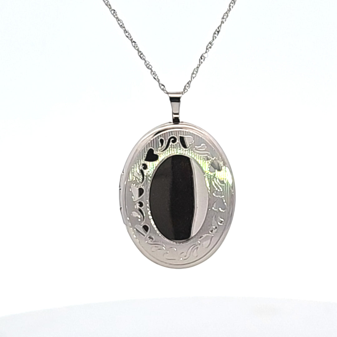 Sterling Silver 26 x 20 mm Rhodium Plated Oval Locket with an Engraved Heart Border Style: W/O Chain